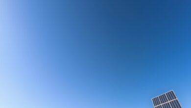 Painéis solares fotovoltaicos instalados numa vasta área rural ensolarada em Moçambique sob um céu limpo