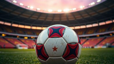 Bola de futebol sobre relvado num estádio moderno durante o entardecer desportivo